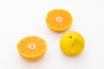 whole and half cut orange on white background