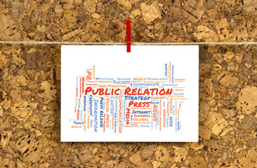Business card with Public Relation word cloud shaped as a arrow to the right on a cork pinboard