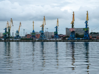 Shipping yard, forklifts near the water, crane