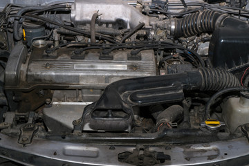 Old and dirty car engine in the garage.