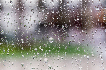 Drops of rain on a window pane, Blur buildings in background.