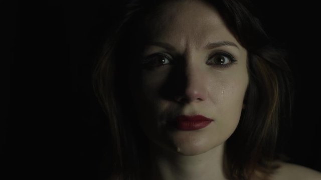 4k shoot of a model crying and acting on black background