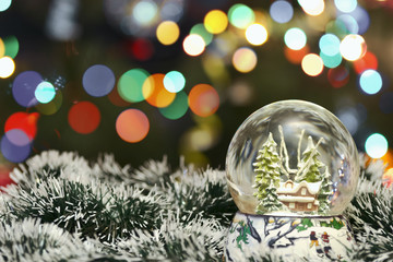 Snowy Glass Ball On A Christmas Bokeh Background