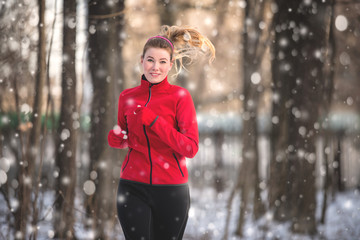 Running woman in winter forest