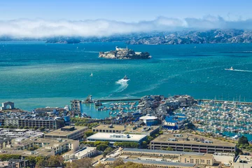 Fotobehang Aerial view of Alcatraz Island, Hyde Street Pier in Fisherman's Wharf and Maritime National Historical Park, from top of Coit Tower on sunny day. San Francisco, California, Unites States. © bennymarty