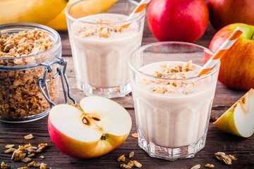 Healthy breakfast: smoothie with granola, red apple and  banana
