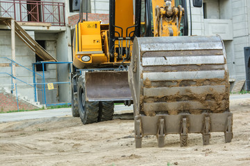 Fototapeta na wymiar Backhoes standing at construction site