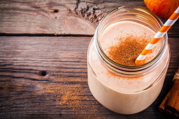 Smoothies with red apple and cinnamon in a glass mason jar