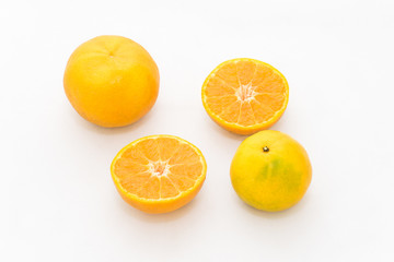 whole and half cut orange on white background