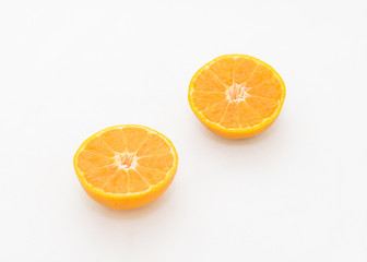 whole and half cut orange on white background