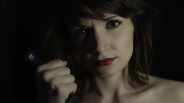 4k shoot of a woman in studio showing her knife