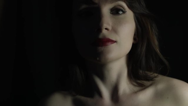 4k shoot of a woman in studio moving here face to camera