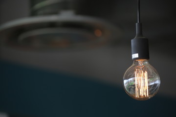 a light bulb with a filament against a dark background