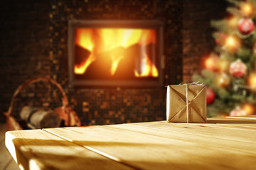 Fototapeta premium xmas tree fireplace and wooden desk space 