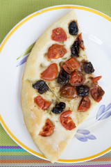 pizza with black olives and cherry tomatoes