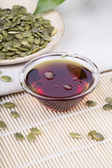 Fototapeta premium Pumpkin seed oil and seeds on the table