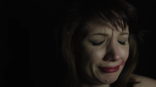 4k shoot of a woman in studio crying and acting