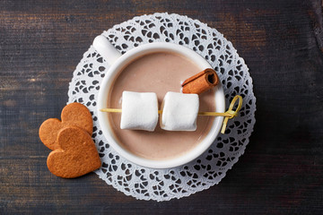 Cup of hot cocoa drink with sweets from above