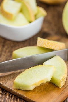 Portion of Honeydew Melon on wooden background (selective focus)