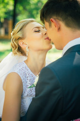Fototapeta premium portrait the bride and groom on the background of the park alley