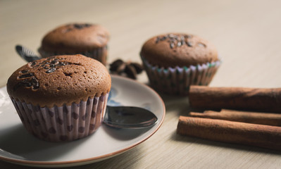 Cup cake on wood background with coffee cup.Vintage tone.Selective focus.