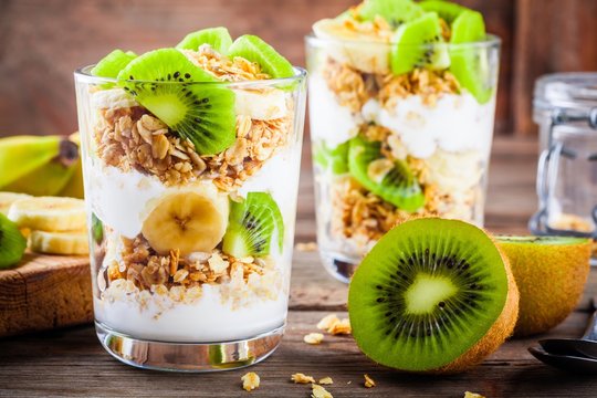 Healthy breakfast: yogurt parfait with granola, banana and kiwi