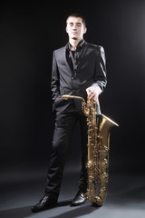 Obraz na płótnie Canvas Saxophone Player Saxophonist jazz man with Sax baritone