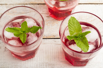 red drink with mint and ice top view