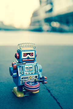 Old robot toy, vintage color style, vintage tone background.