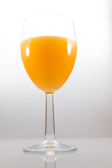 Frontal view of an Isolated glass of orange juice