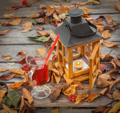 Glass with fragrant mulled wine near a lantern