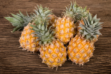 group of pineapple on wooden table