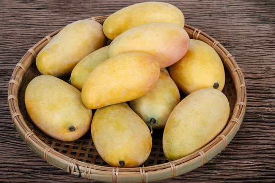 Golden ripe mangoes in basket on sale