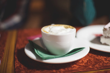 Flat white cup of coffee latte, close up, shallow dof