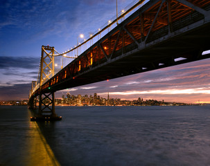 San Francisco skyline framed by the Bay Bridge at sunset 