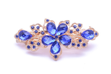 gold brooch with blue stones isolated on white