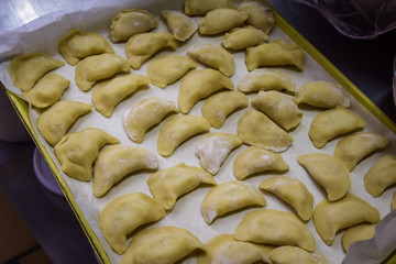 raw ravioli with potato and cheese during cooking