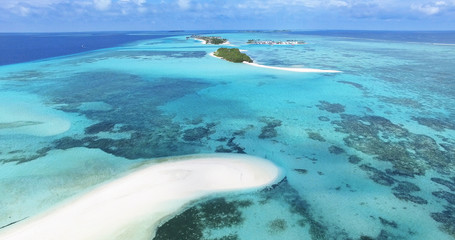 Panoramic landscape seascape aerial view over a Maldives Male Atoll islands. White sandy beach seen...