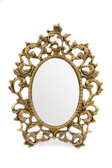 Antique mirror in a gold frame on white background