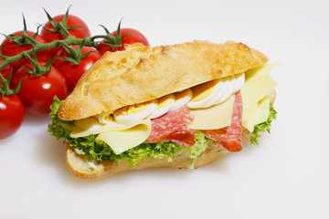 Baguette bun, salami, cheese, lettuce and boiled eggs