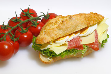 Baguette bun, salami, cheese, lettuce and boiled eggs