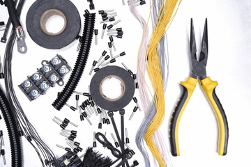 Electrical Accessories and Tool on Metal Background Top View