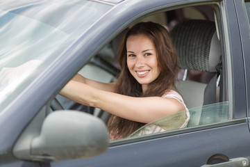 Portrait of young woman in car