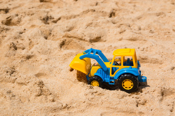 Children's Toy excavator in the sand