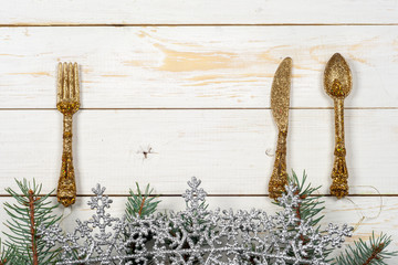 Vintage silverware on rustic wooden background with Christmas decoration