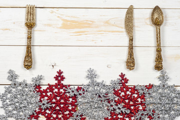 Vintage silverware on rustic wooden background with Christmas decoration