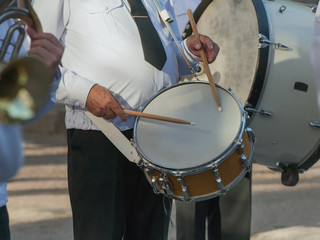 Fototapeta na wymiar Drummer plays snare drum in a Marching Band