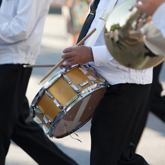 Drummer plays snare drum in parade