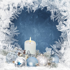 Fototapeta na wymiar Christmas background with candles, pine branches, balls on a blue background with a frosty pattern