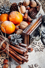 Christmas composition, Tangerines, pine Cones, Snowflakes ,decor, Bunch of Cinnamon, Walnut.Brown Wooden Background.